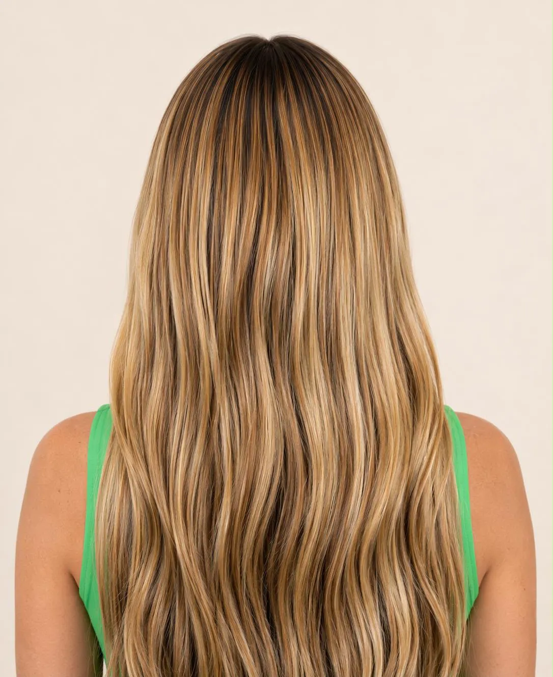 The completed result from behind: long, full, highlighted hair.